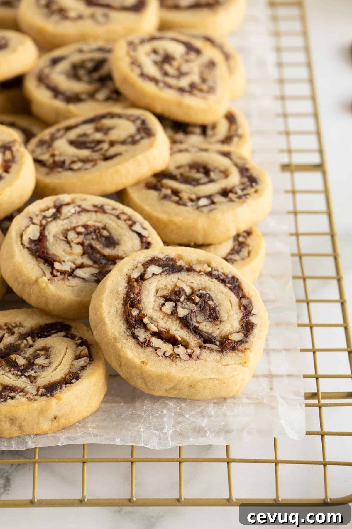Date Pinwheel Cookies Recipe — Irresistible Swirls of Sweet Date Filling 3 Date pinwheel cookies piled on a wire rack.