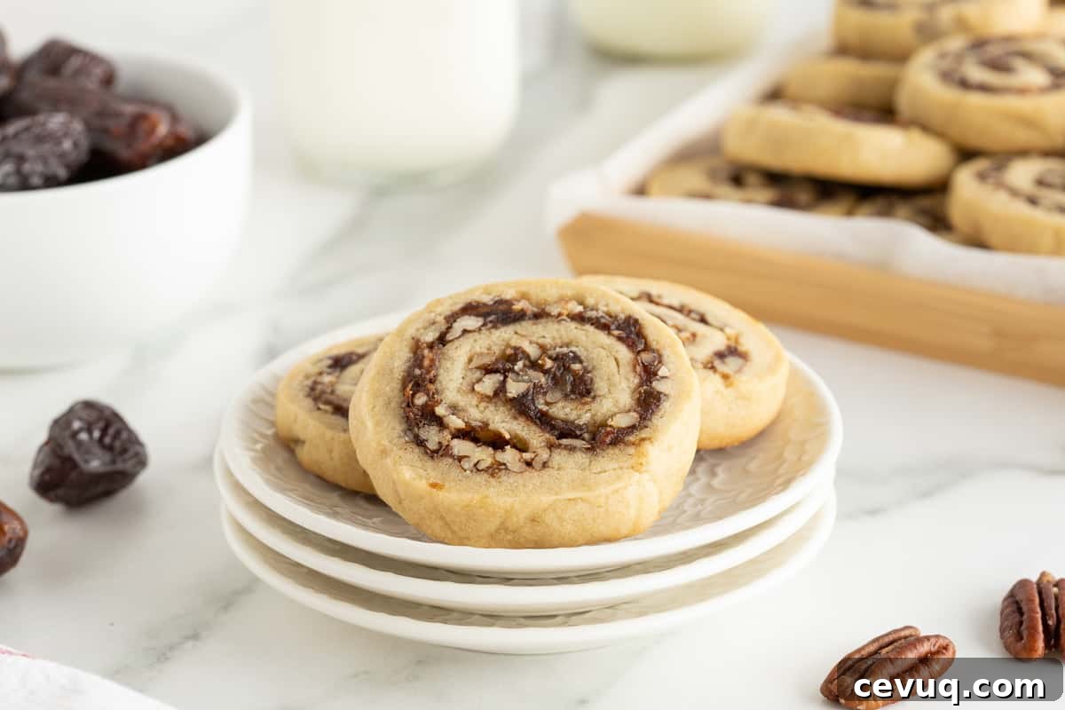 Date Pinwheel Cookies Recipe — Irresistible Swirls of Sweet Date Filling 5 Three date pinwheel cookies on stack of small white plates.