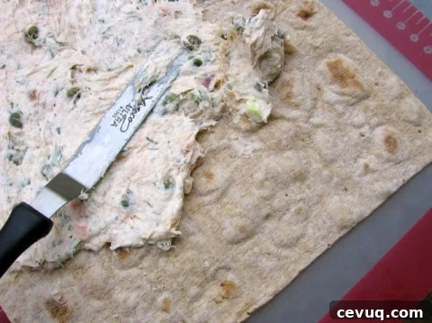 Spreading salmon spread mixture on lavash.