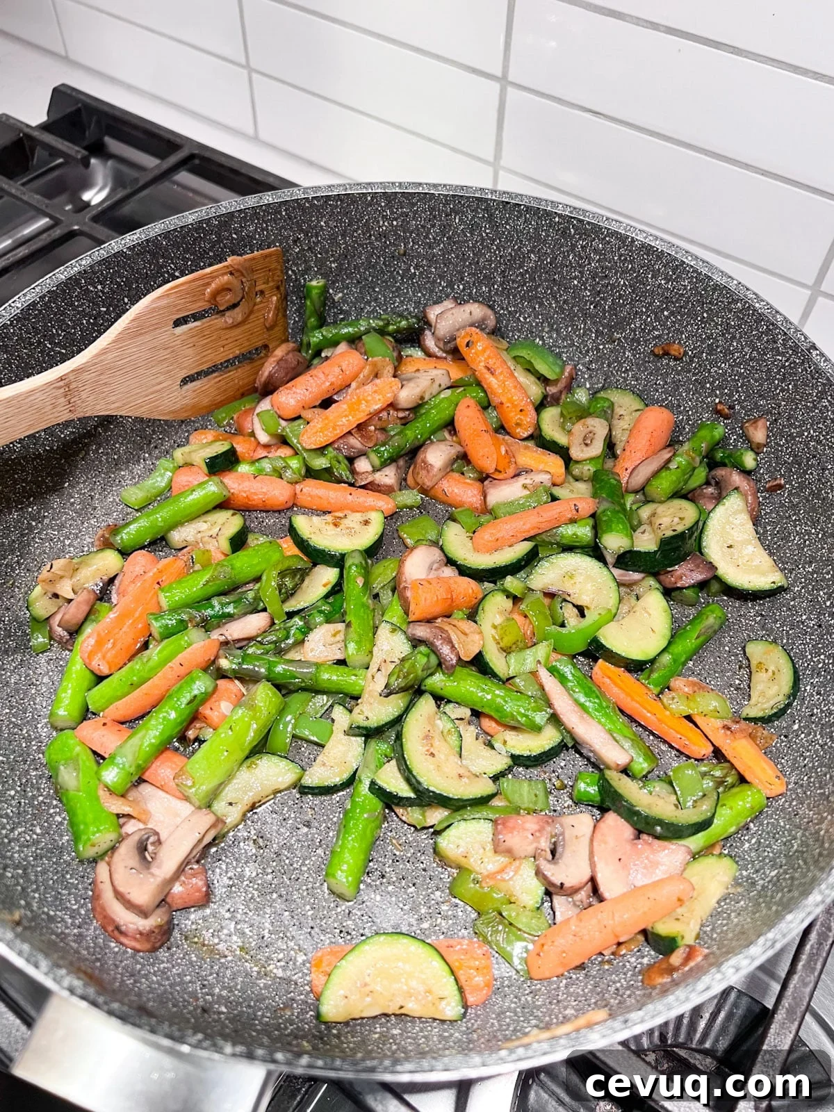 Mushrooms, peppers and seasoning added to sauté pan.