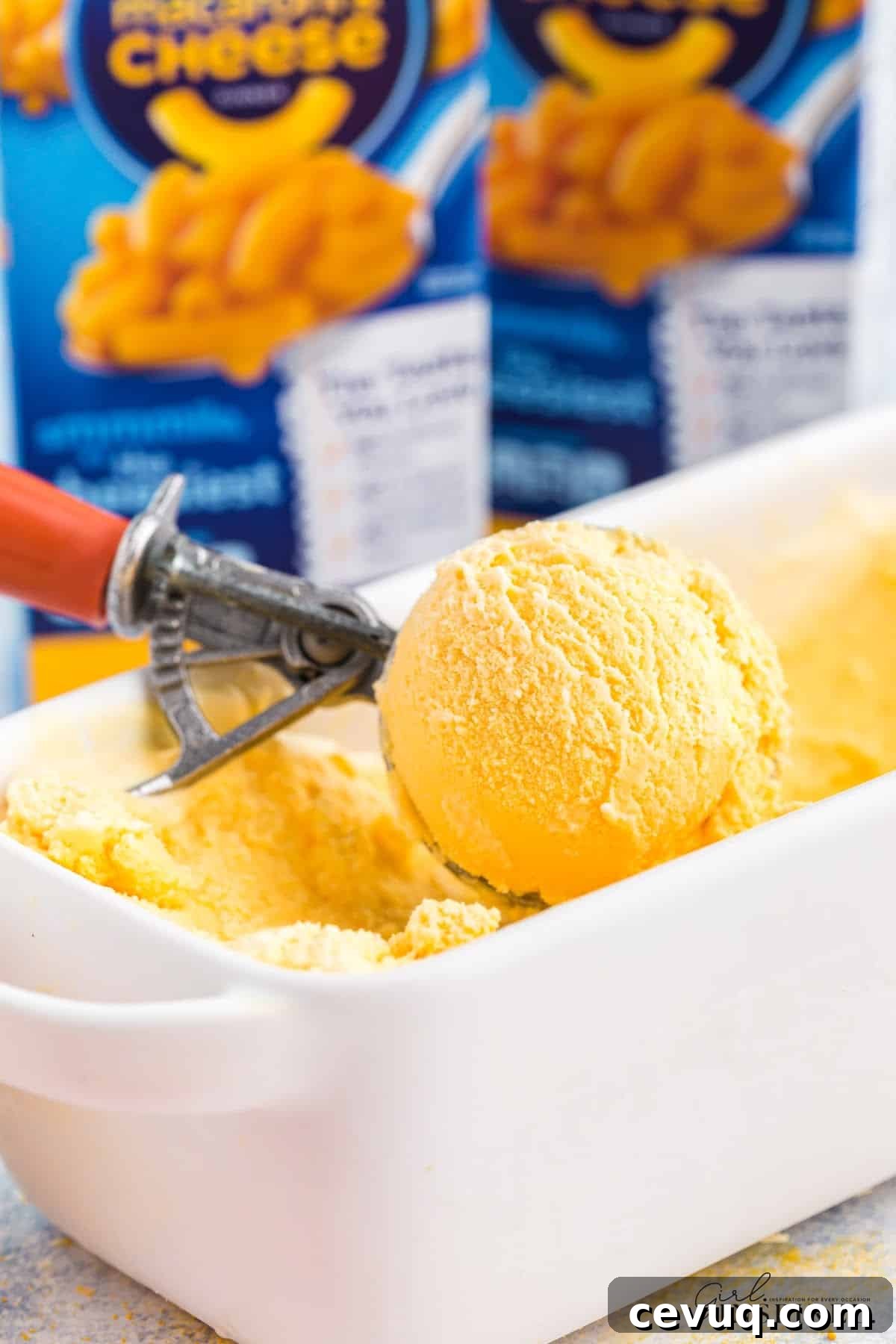 Copycat Mac and Cheese Ice Cream Recipe 11 Scooping the Mac and Cheese ice cream out of the bowl.