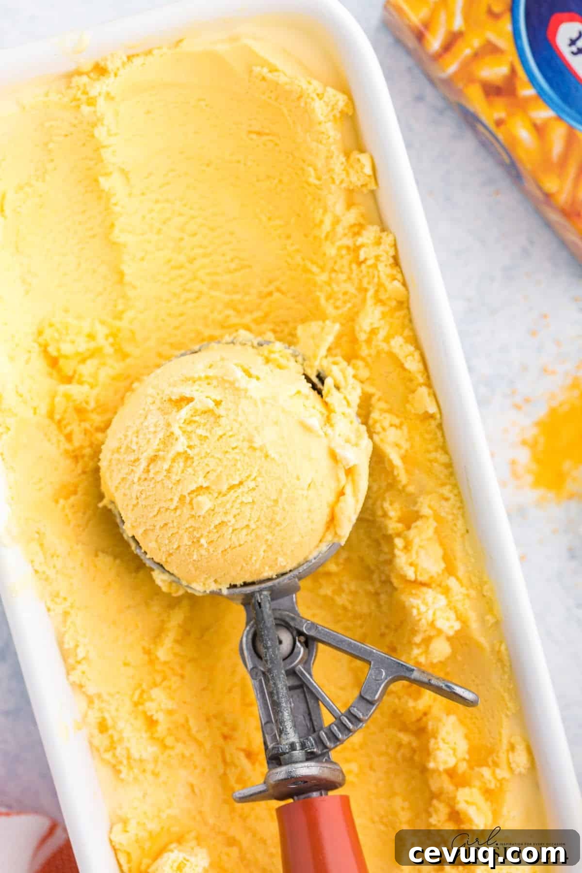 Copycat Mac and Cheese Ice Cream Recipe 10 Scooping the Mac and Cheese ice cream out of the bowl.