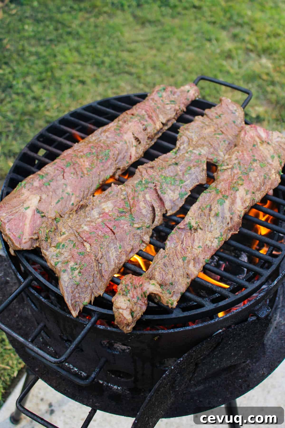 three pieces of steak on a grill