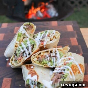 a pile of california burrito halves piled on a cutting board