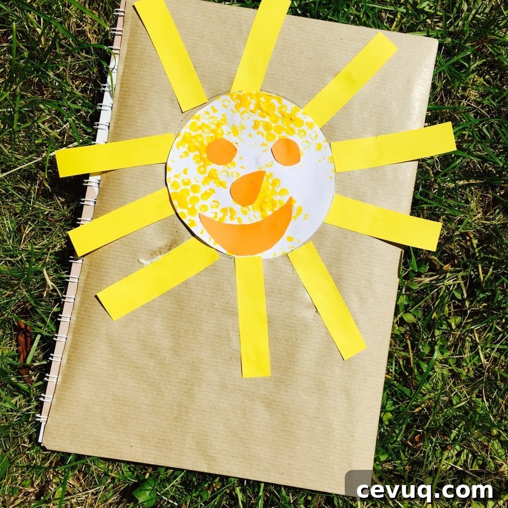 finger print sunshine stuck on the front of a summer scrapbook