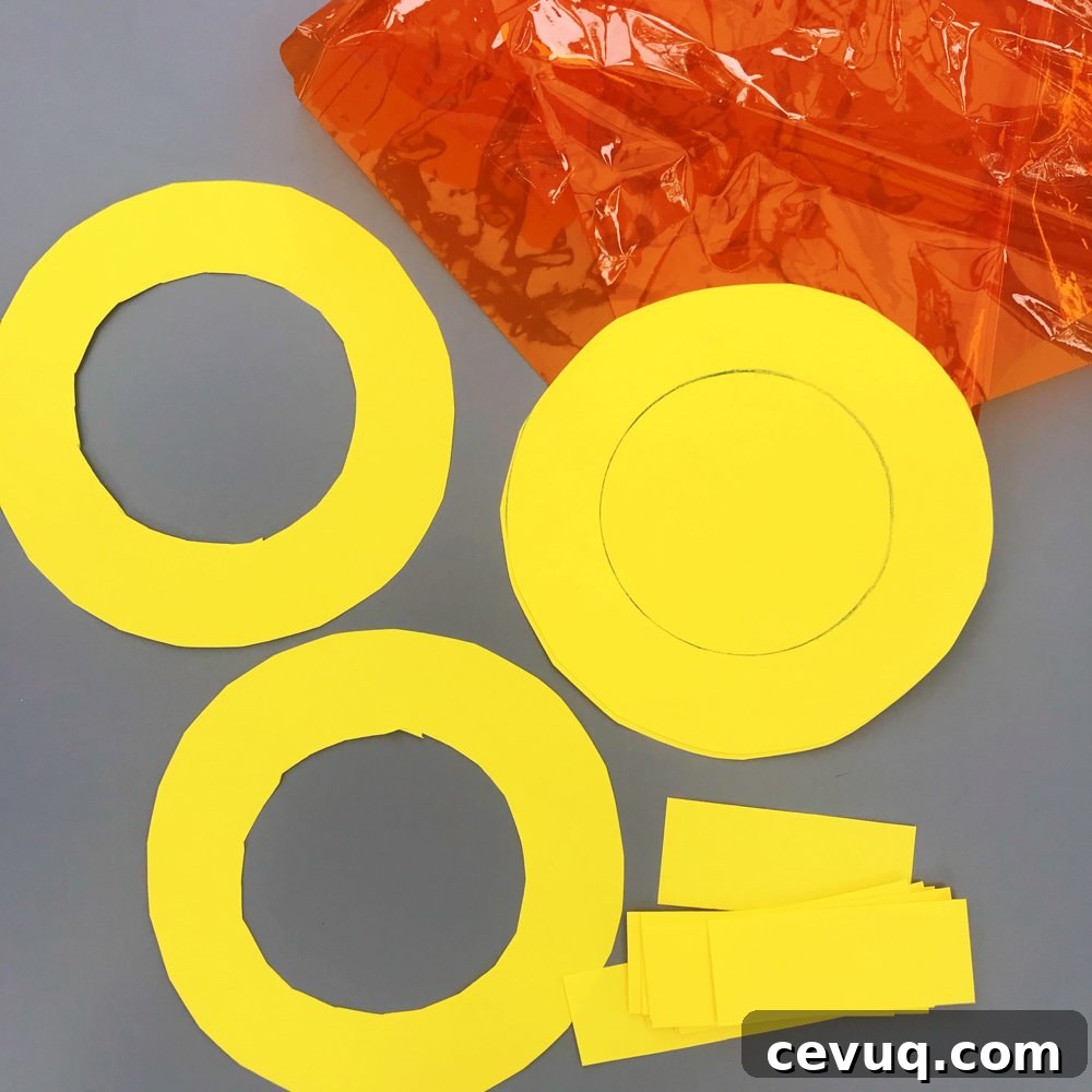 yellow paper and orange acetate cut out ready for sunshine crafts