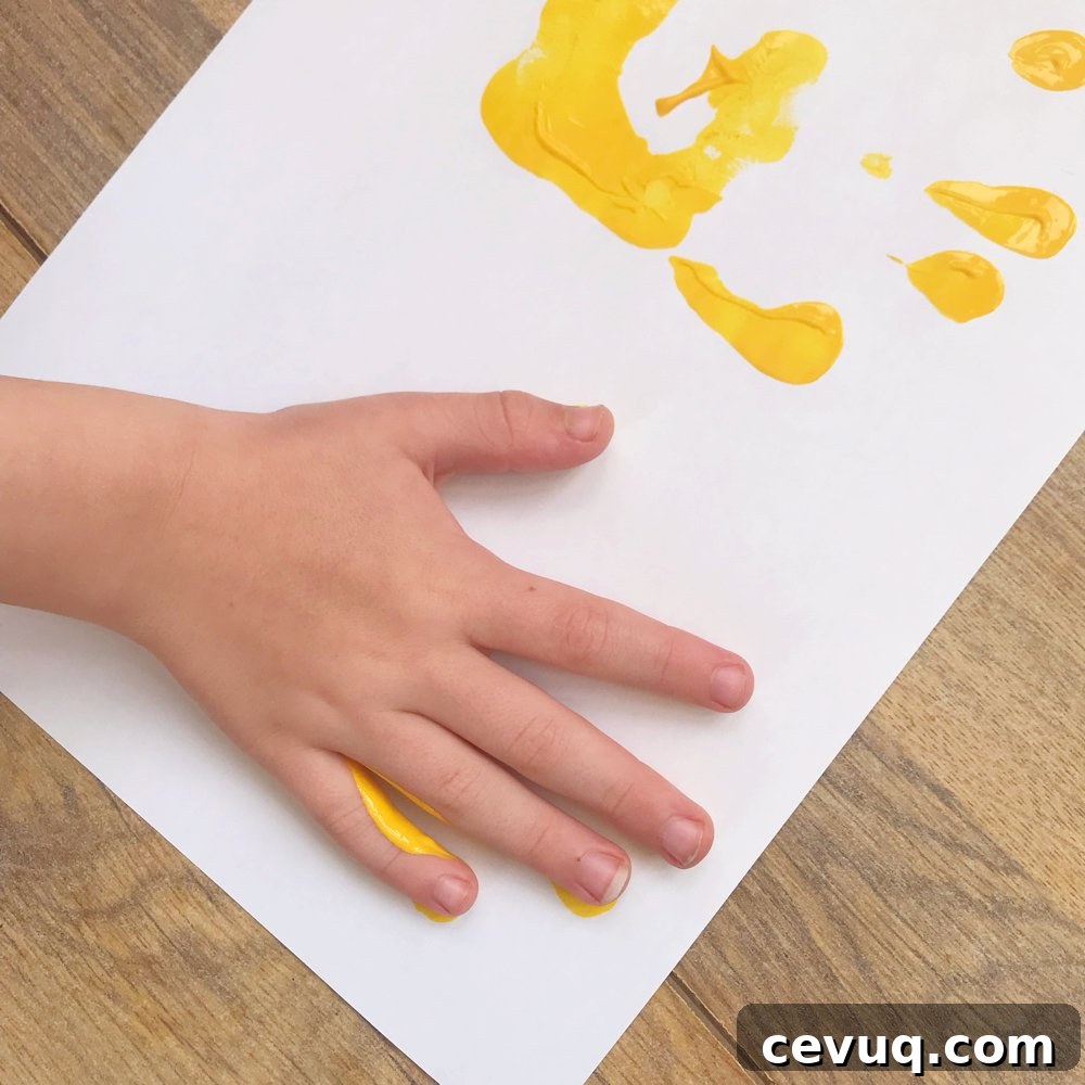 child handprints forming a sun shape
