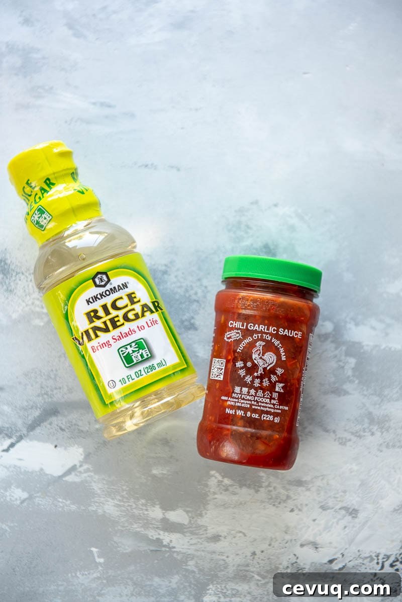 bottle of rice vinegar and jar of sriracha sauce
