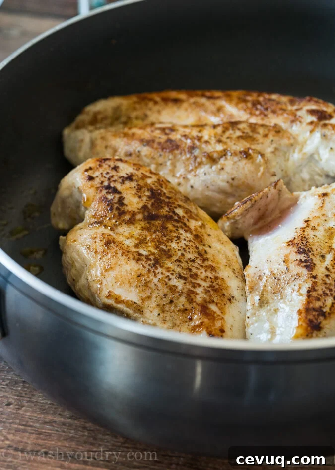 Season three large chicken breasts and sear in a large skillet until browned on each side.