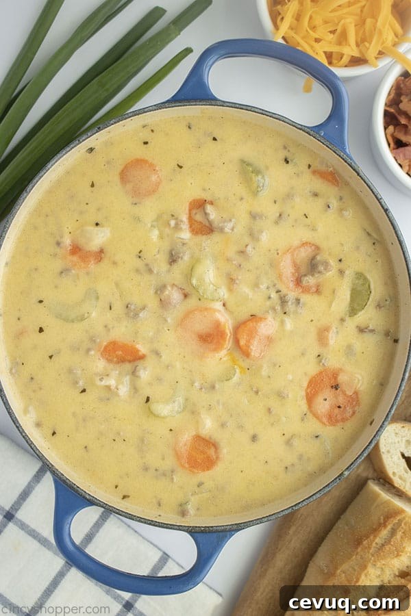 Creamy Cheeseburger Soup with vegetables in a pot