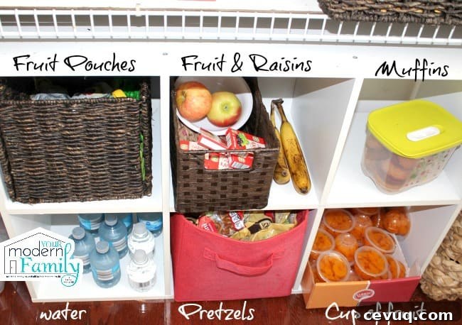 A divided shelf with a variety a different food items in each space.