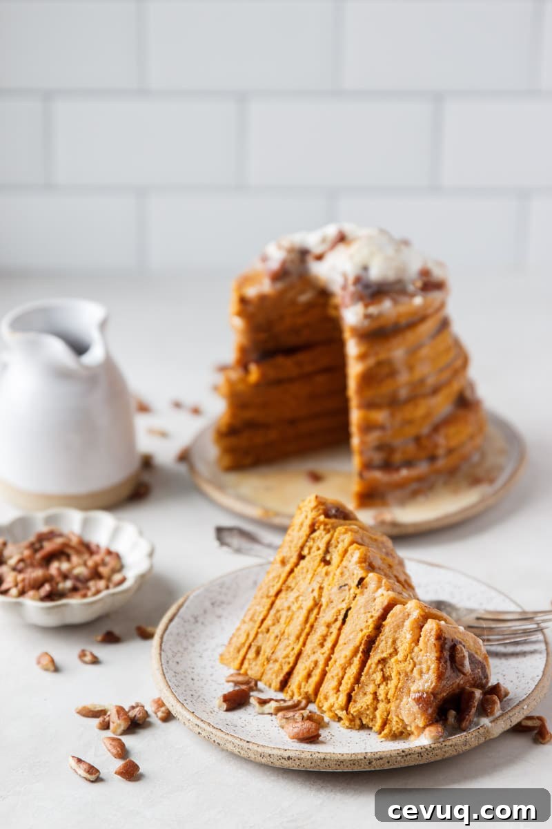 Stack of pumpkin pancakes with pecans and syrup