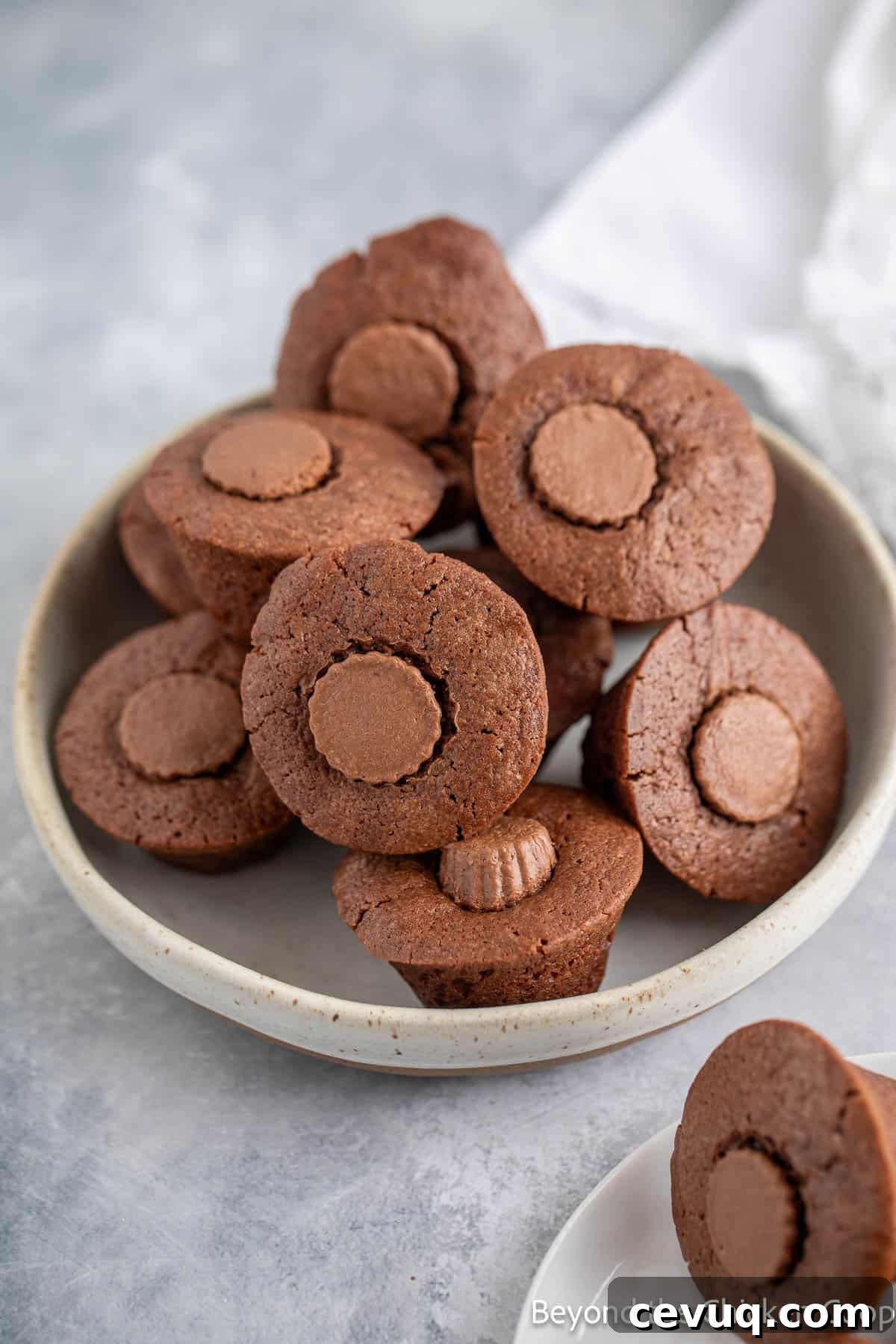 Mini peanut butter brownies stacked in a bowl.