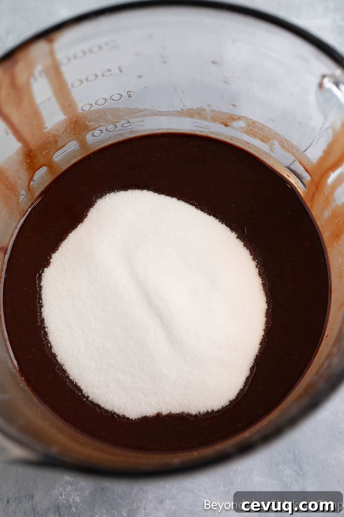 Sugar added to melted chocolate.
