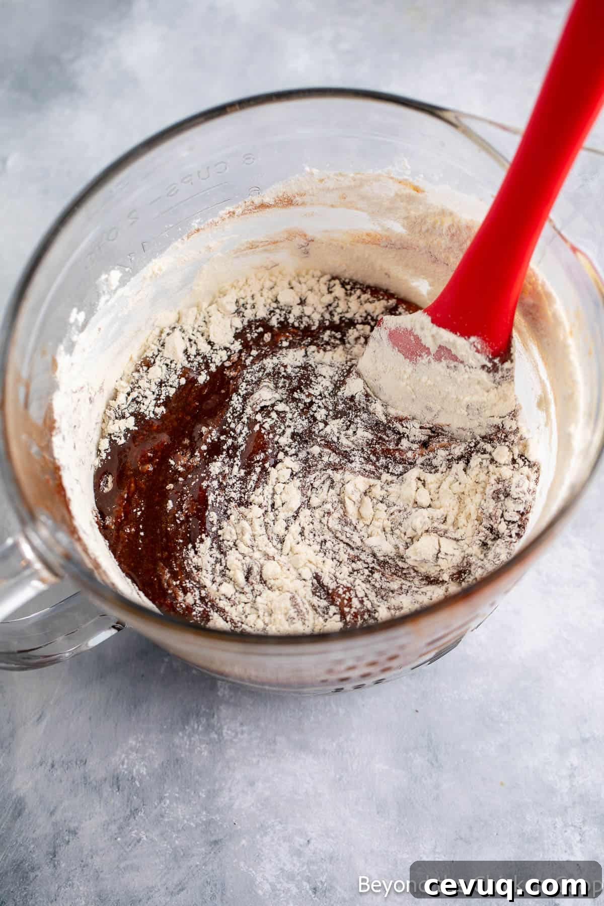 Folding flour into brownie batter.