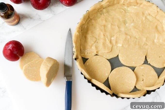 A fruit plum tart with almond frangipane and crumbly sweet pastry.