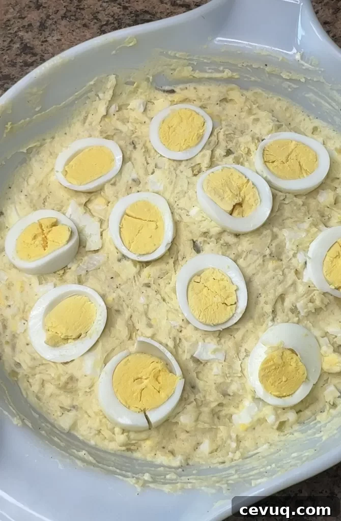 Potato salad garnished with eggs and paprika