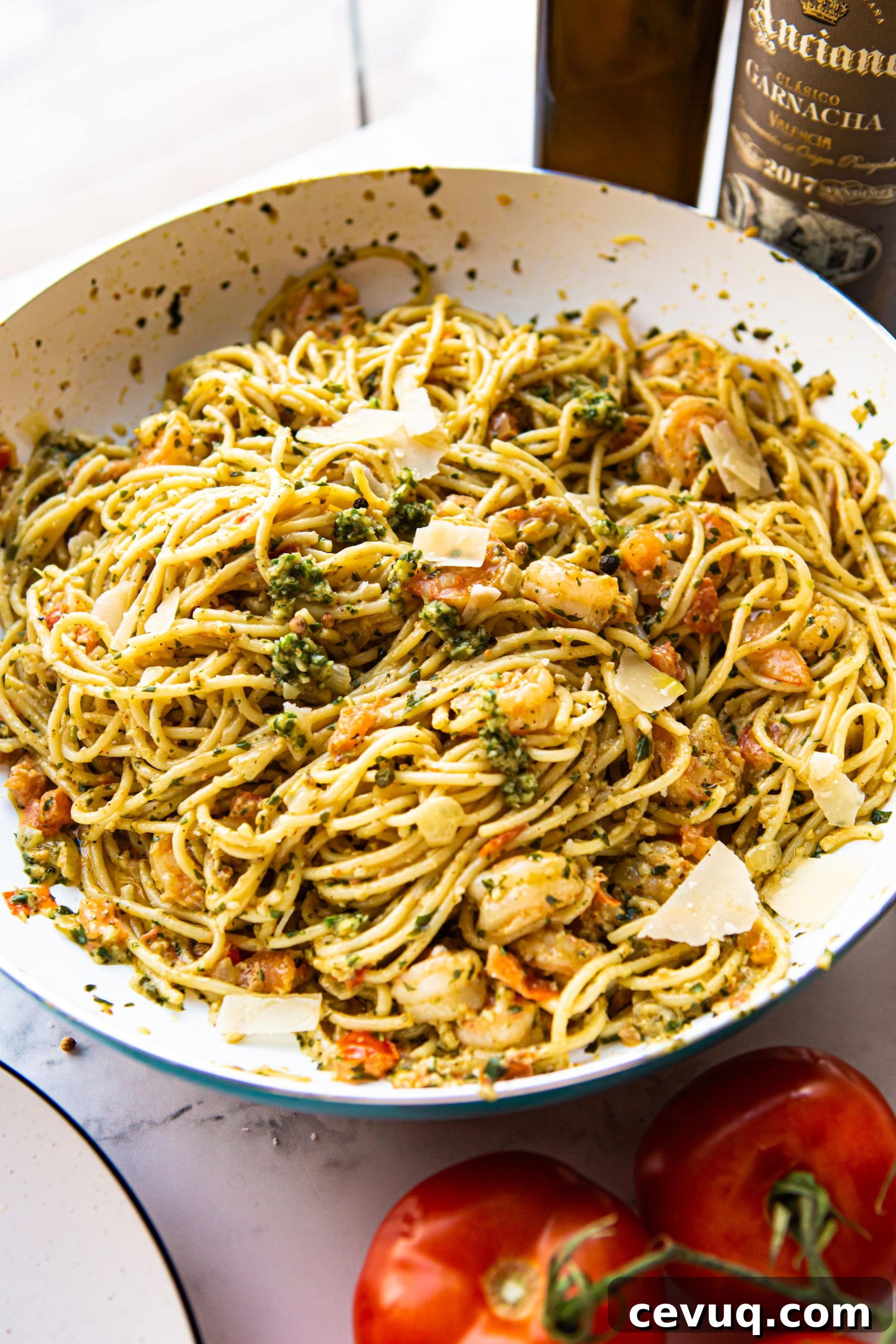 shrimp pesto pasta in a skillet.