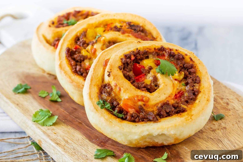 These taco pizza rolls are easy to make and taste amazing! Homemade pizza dough wrapped around taco meat, cheese and veggies - perfect for lunch or dinner!