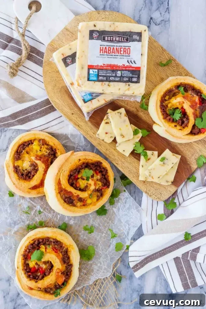 These taco pizza rolls are easy to make and taste amazing! Homemade pizza dough wrapped around taco meat, cheese and veggies - perfect for lunch or dinner!