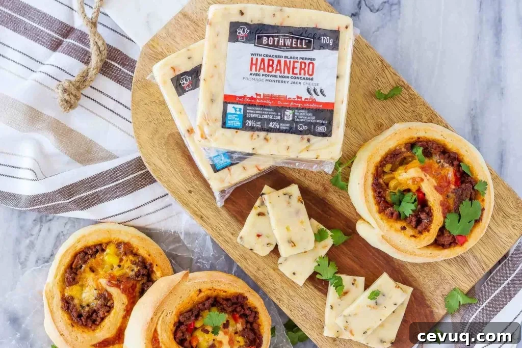 These taco pizza rolls are easy to make and taste amazing! Homemade pizza dough wrapped around taco meat, cheese and veggies - perfect for lunch or dinner!