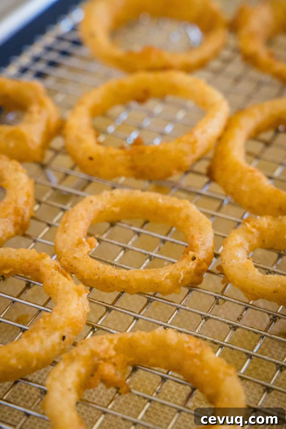 onion rings on a wire rack cooling