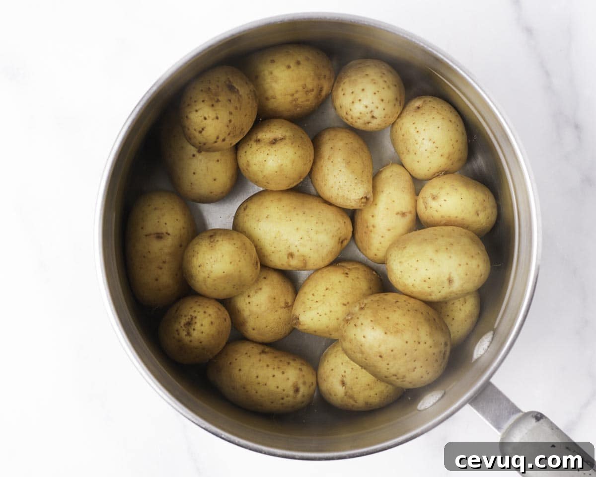 Boiled baby potatoes draining in a colander
