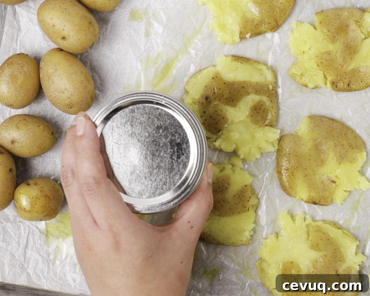 Smashing potatoes on a baking sheet