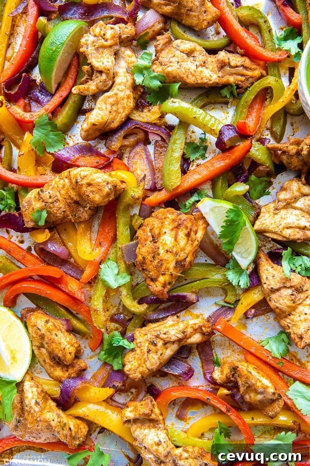 chunks of juicy chicken breast baked on a sheet pan with assorted vegetables