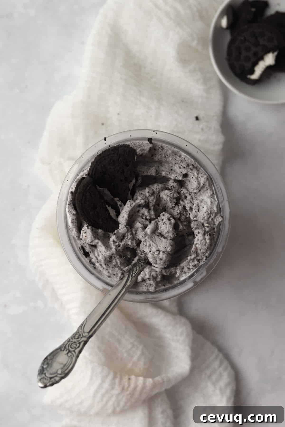 Ninja Creami Oreo Blizzard in the pint container with extra Oreo cookies.