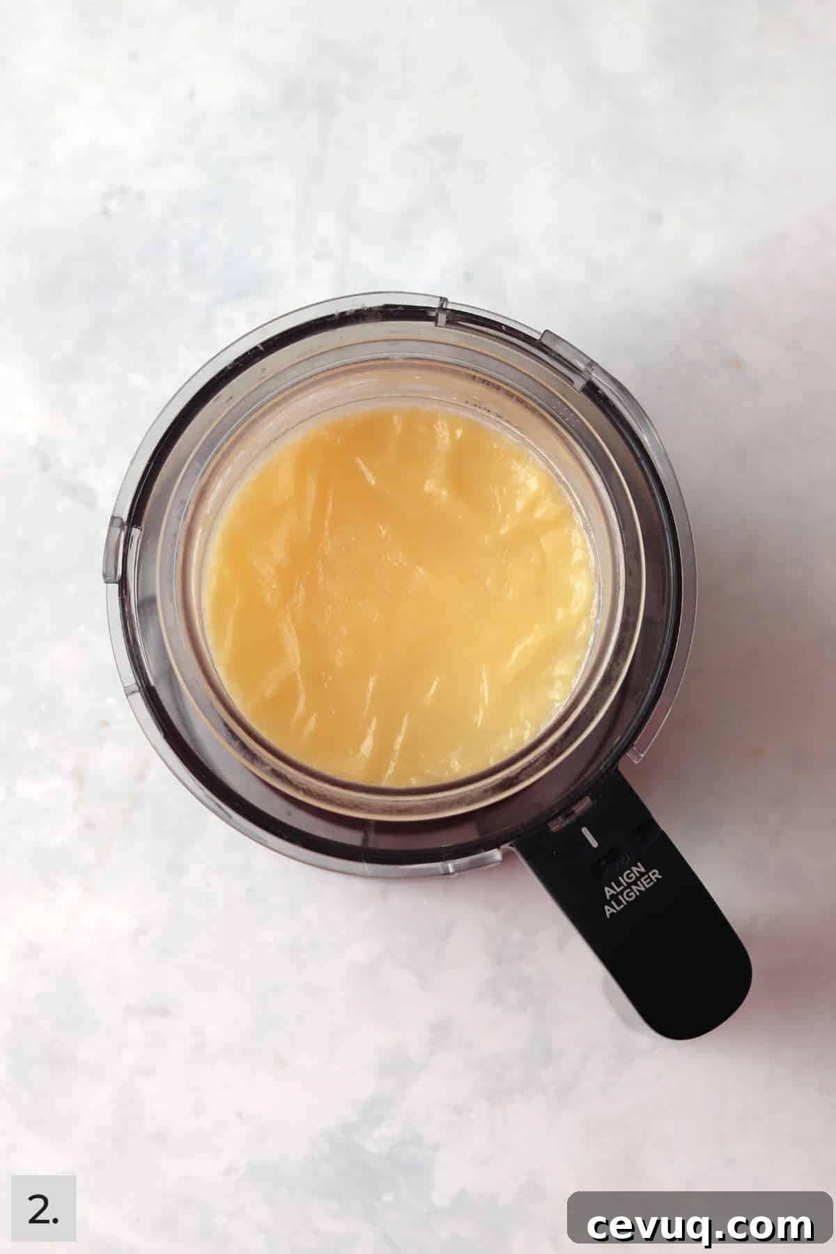 Frozen milk mixture in Ninja Creami pint.