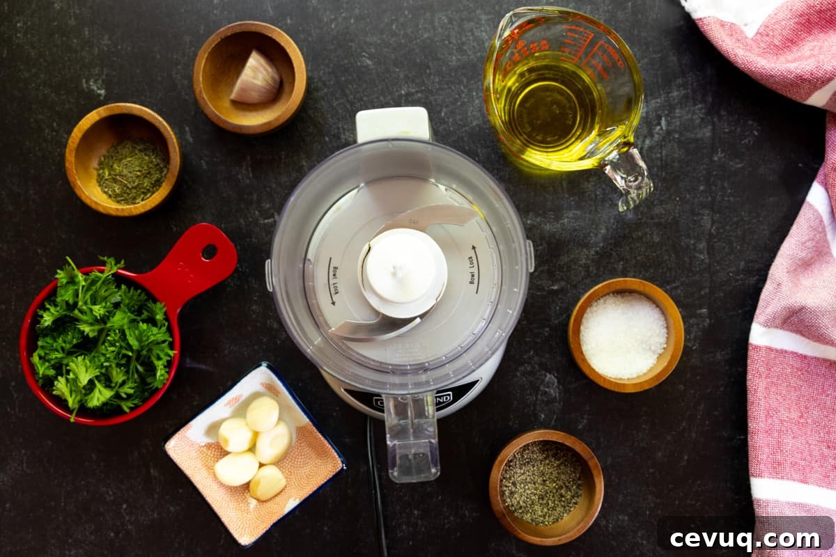 Food processor with small dishes of garlic, parsley, shallot, salt, pepper, & olive oil.