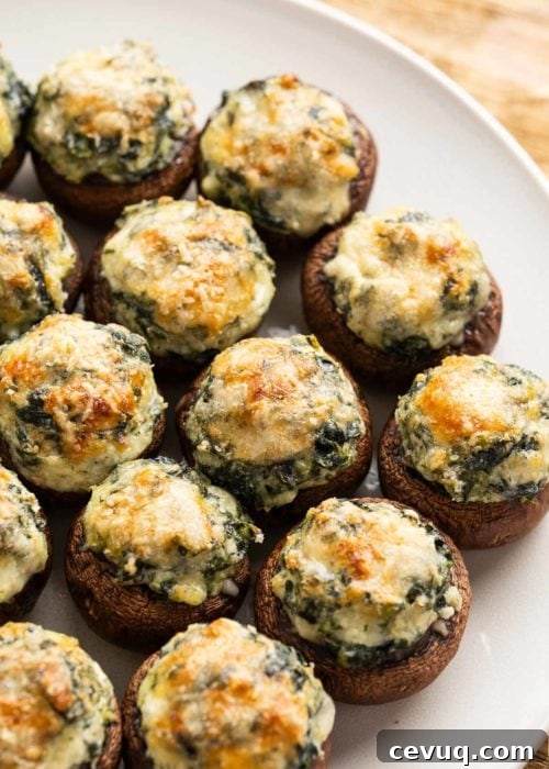 closeup view of spinach and mozzarella stuffed mushrooms