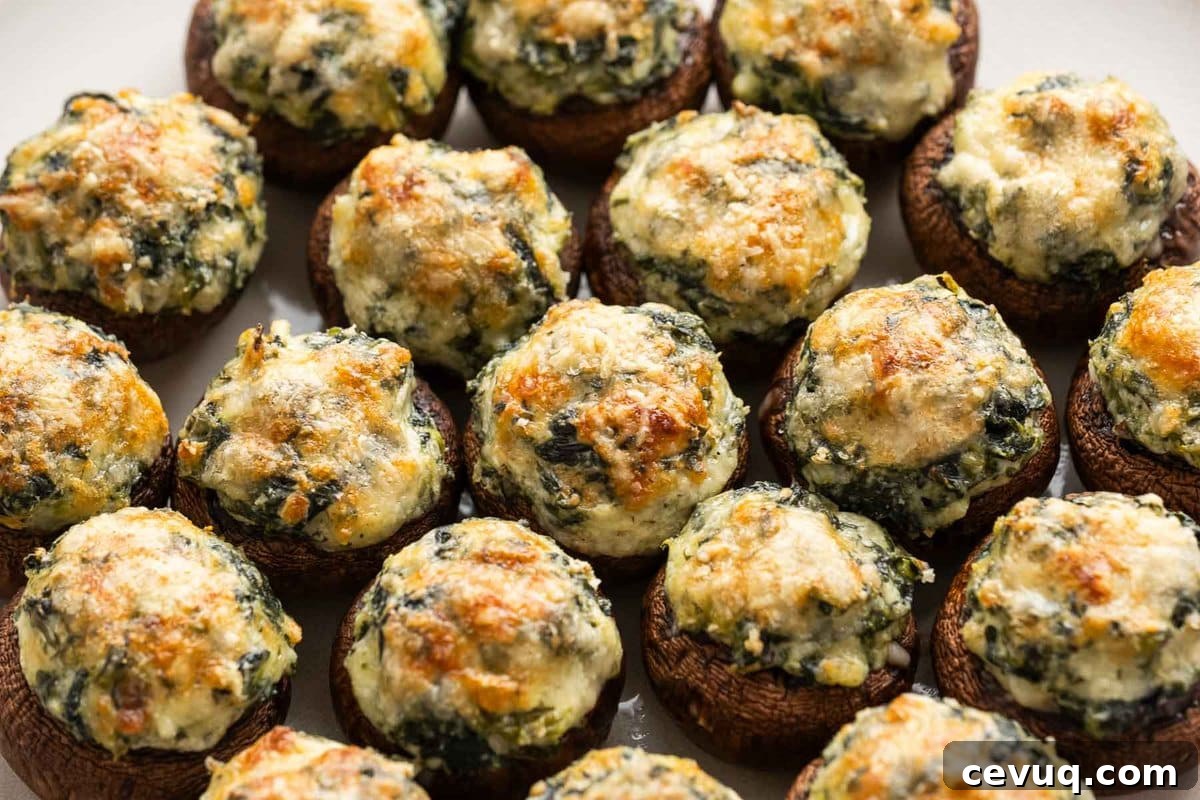 a big plate of stuffed mushrooms with spinach, mozzarella, and parmesan