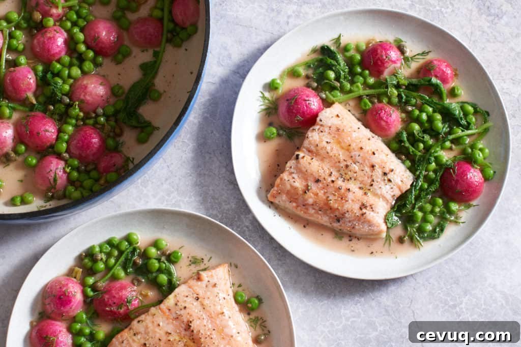 Two white plates of baked salmon with peas and radishes next to a blue pan of the same.