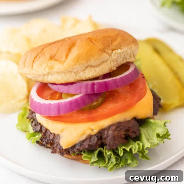 Blackstone Grill Garlic Bread Recipe: Crispy Grilled Loaf 8 Blackstone Cheeseburgers topped with lettuce, tomato and melted cheese on a bun.
