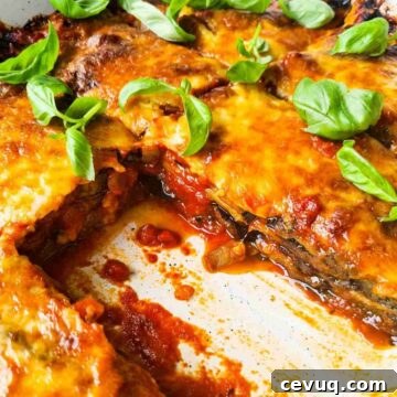 Side view of a tray of eggplant parmigiana with a slice taken out