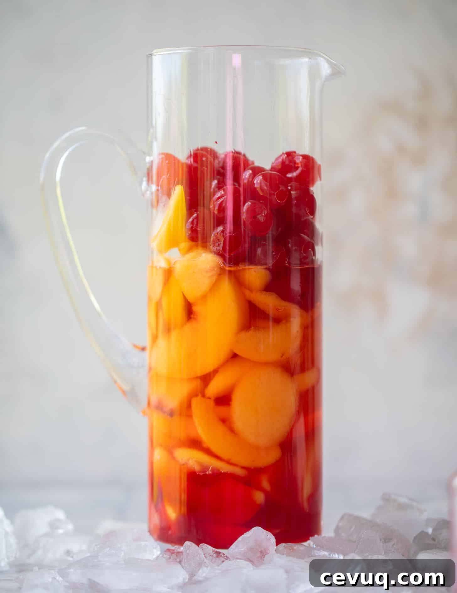 peaches and cherries in a pitcher
