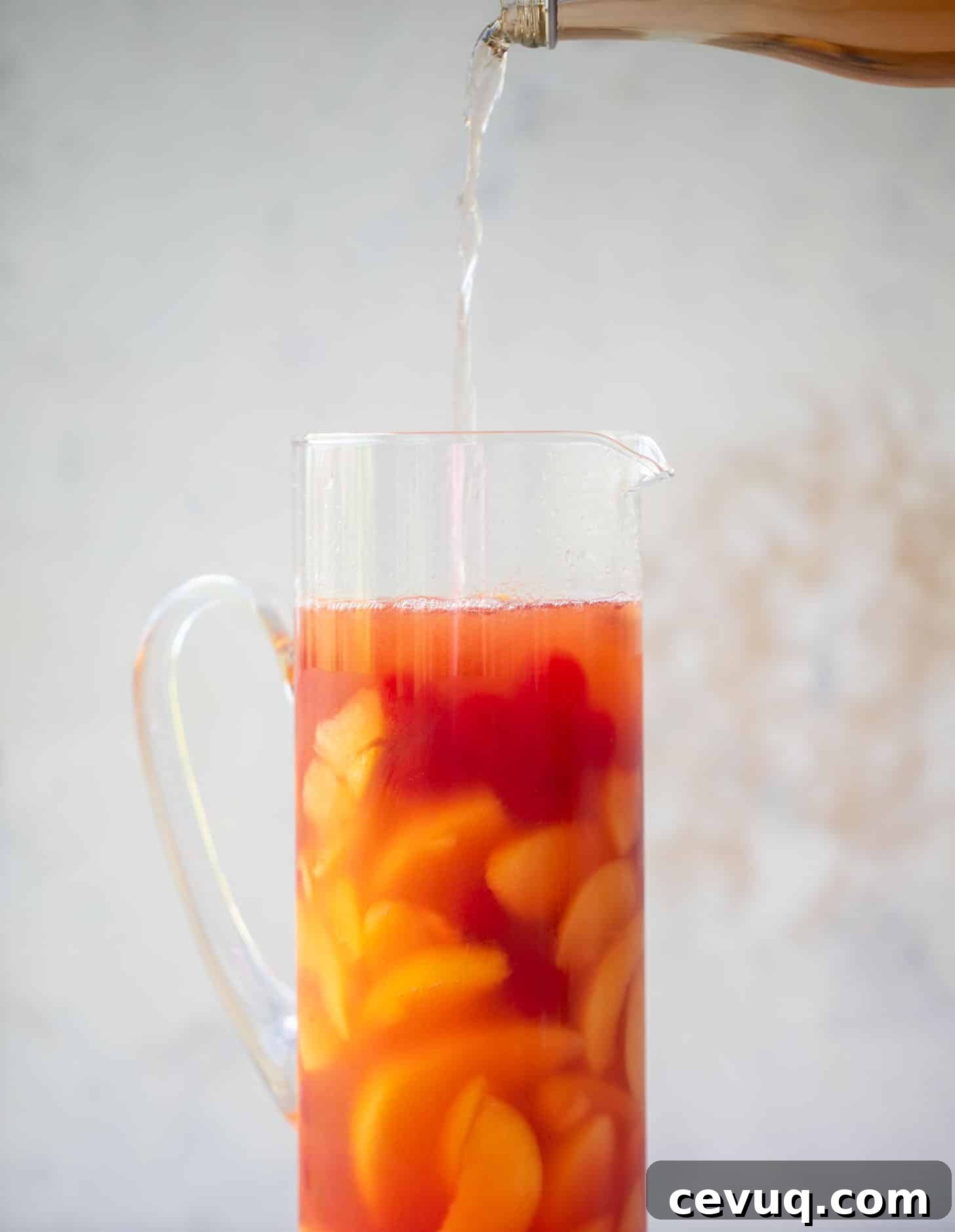 pouring sparkling rose in a pitcher