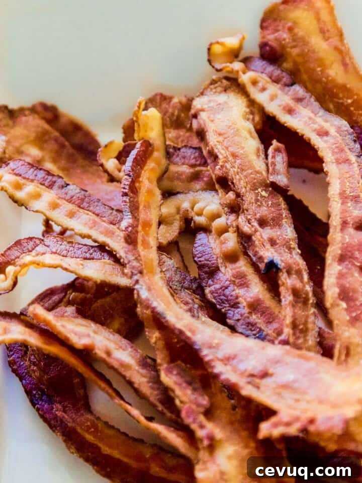 A pile of strips of crisp bacon in a pile to use in a recipe.