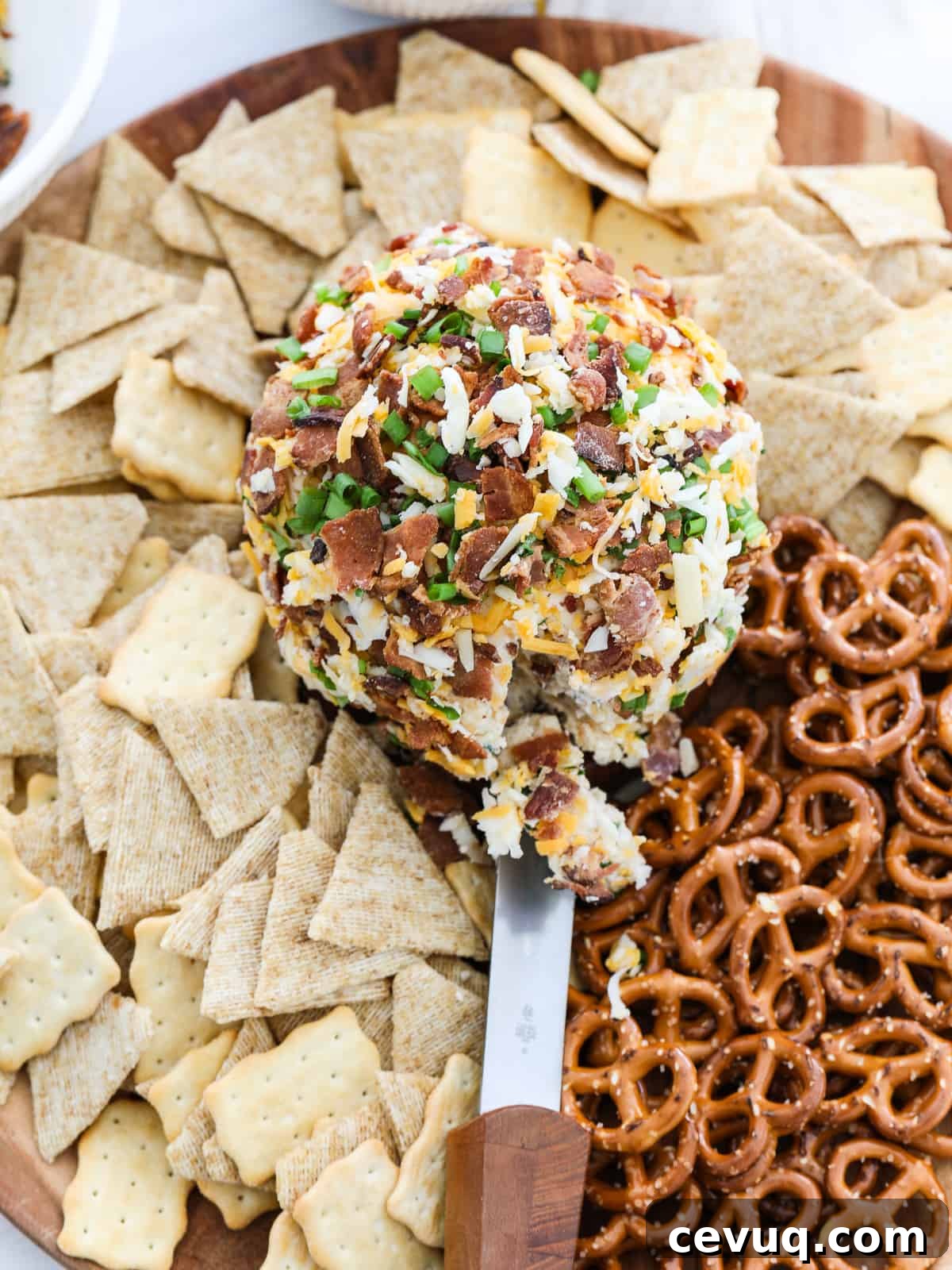 Bacon Cheese Ball on platter with crackers and pretzels