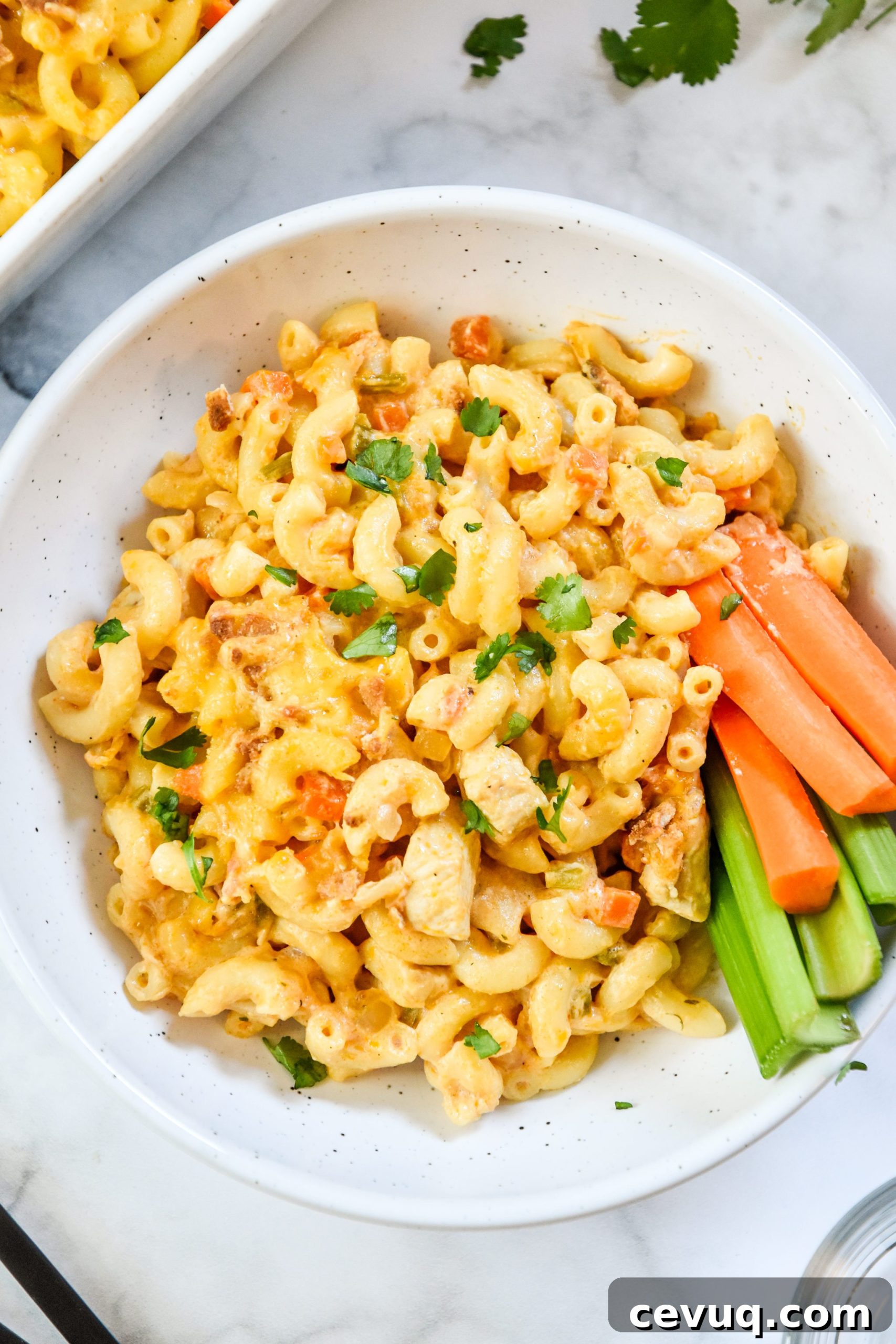 Creamy Buffalo Chicken Mac and Cheese Casserole 5 buffalo chicken mac and cheese in a bowl with carrots and celery