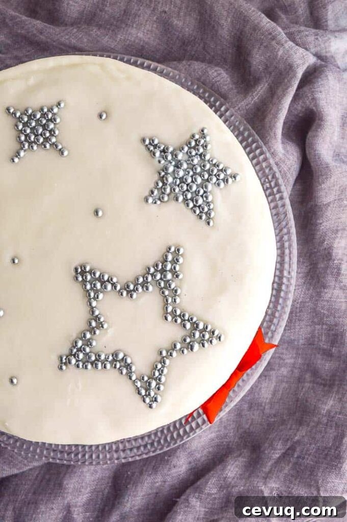 Irish-Style Vegan Christmas Cake Recipe 7 A top-down view of a white frosted cake with silver stars