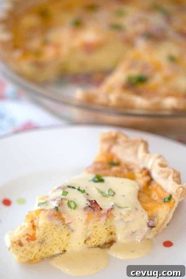 Classic Ham and Cheese Quiche with Flaky Crust 5 Ham quiche on a white plate with hollandaise sauce drizzled over the top.