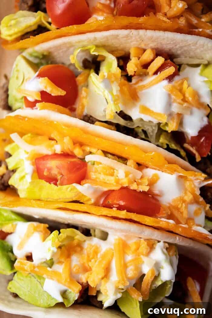 Homemade Chili Seasoning Mix for Authentic, Bold Flavor 13 overhead view of 4 tacos with 2 in cheese shells and 2 in tortillas with meat, lettuce, tomato, cheese and avocado