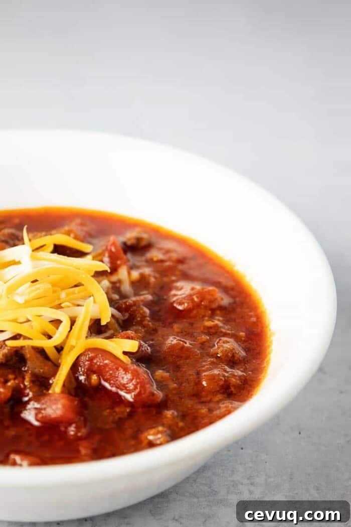 Homemade Chili Seasoning Mix for Authentic, Bold Flavor 4 side view of white bowl containing keto chili topped with cheese