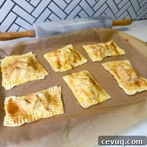Flaky Apple Hand Pies with Puff Pastry 11 Apple hand pies on baking sheet before baking.