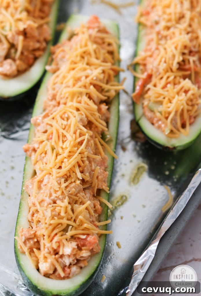 Buffalo Chicken Stuffed Zucchini Boats on a sheet pan ready to bake.