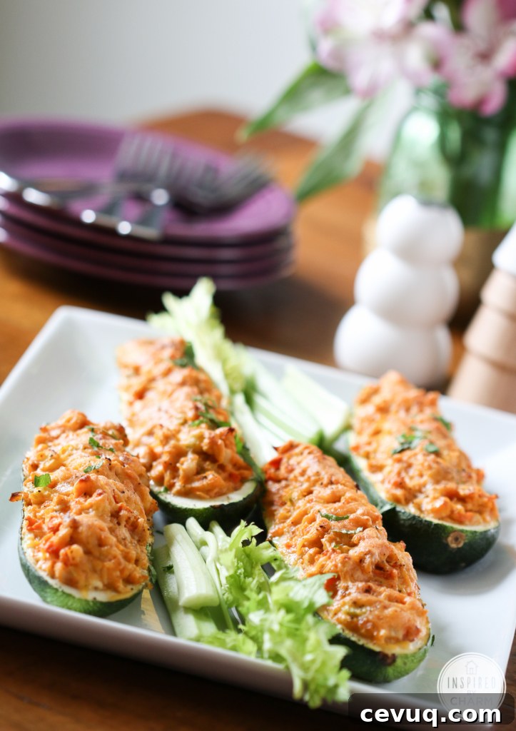 Buffalo Chicken Zucchini Boats served on a white serving dish.