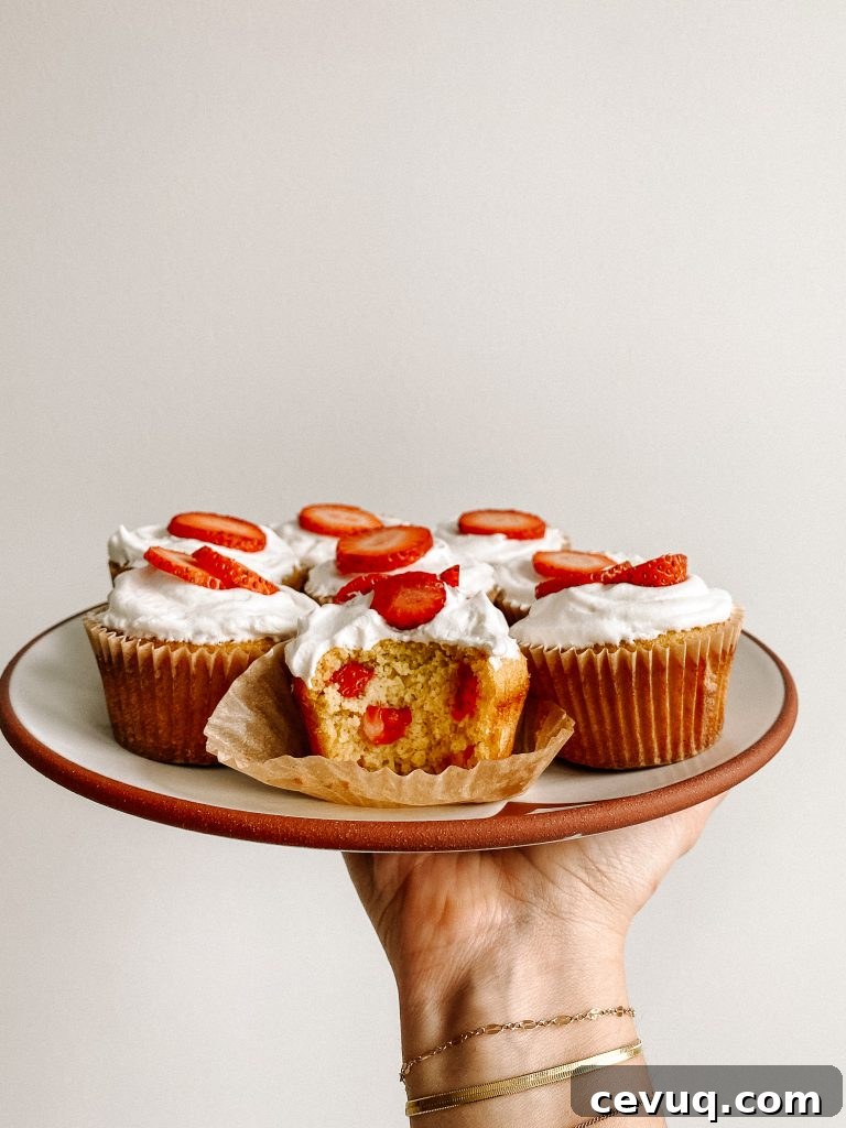strawberry shortcake cupcakes on a plate in the air